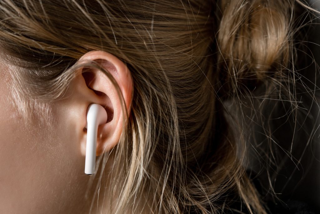 A wireless earphone in the left ear