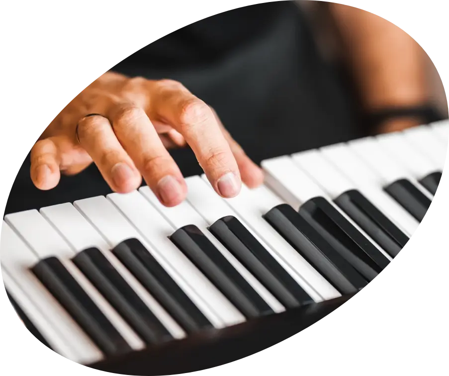 Right hand playing a note on a piano keyboard